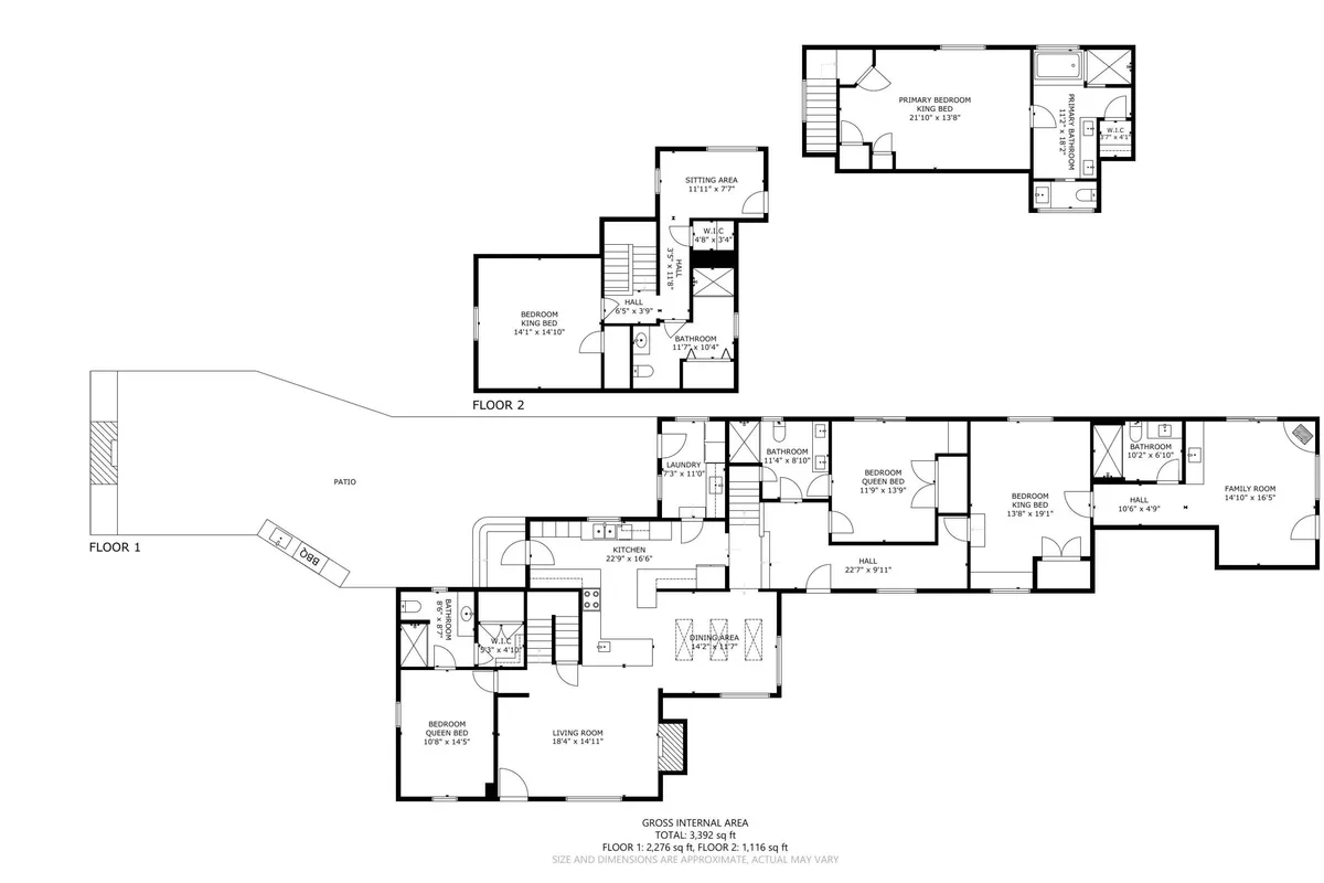 A wide, open interior view seamlessly integrating the kitchen, living room, and dining area. The space is filled with natural light pouring through large windows, and the furnishings are modern yet comfortable. Family members are engaged in various activities such as cooking, relaxing, and gathering, highlighting a lively and inviting atmosphere.