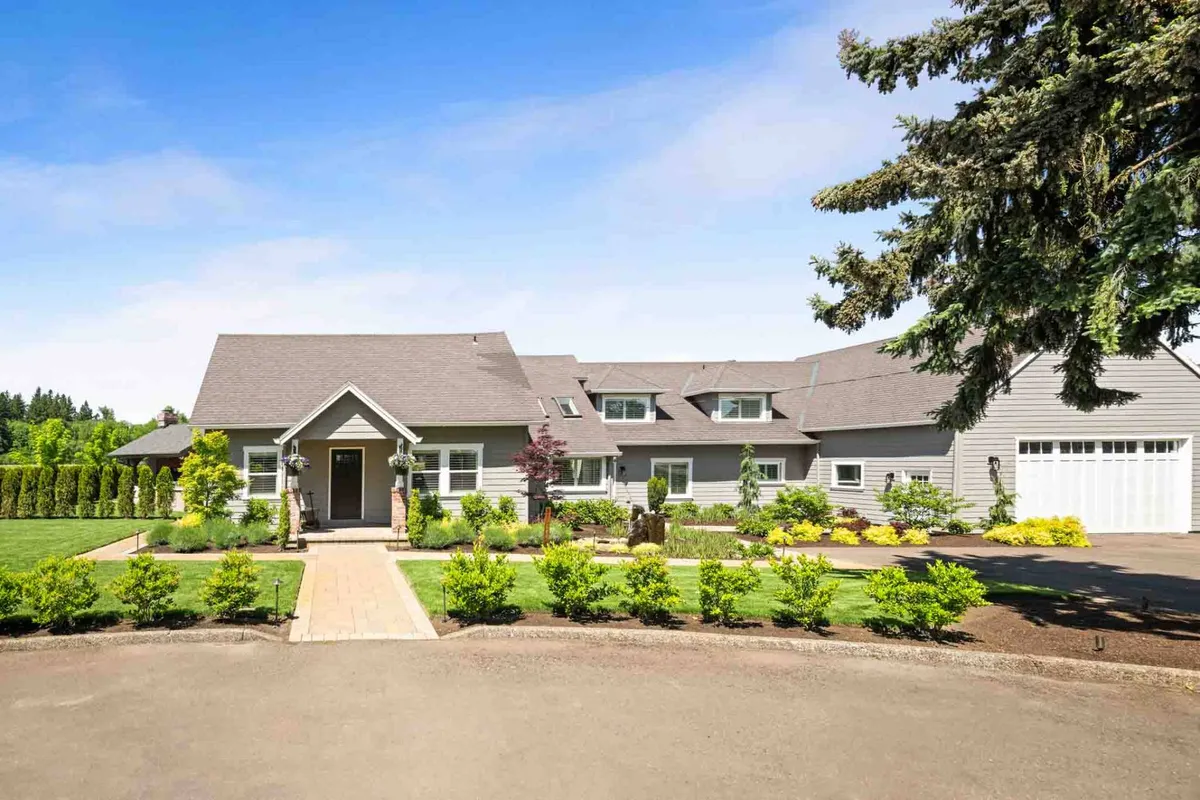 This exterior shot centers on the front entrance, landscaped garden, driveway, and garage. The garden is lush and well-kept, while the entrance feels welcoming—suggesting a home that’s both inviting and safe for families and pets.